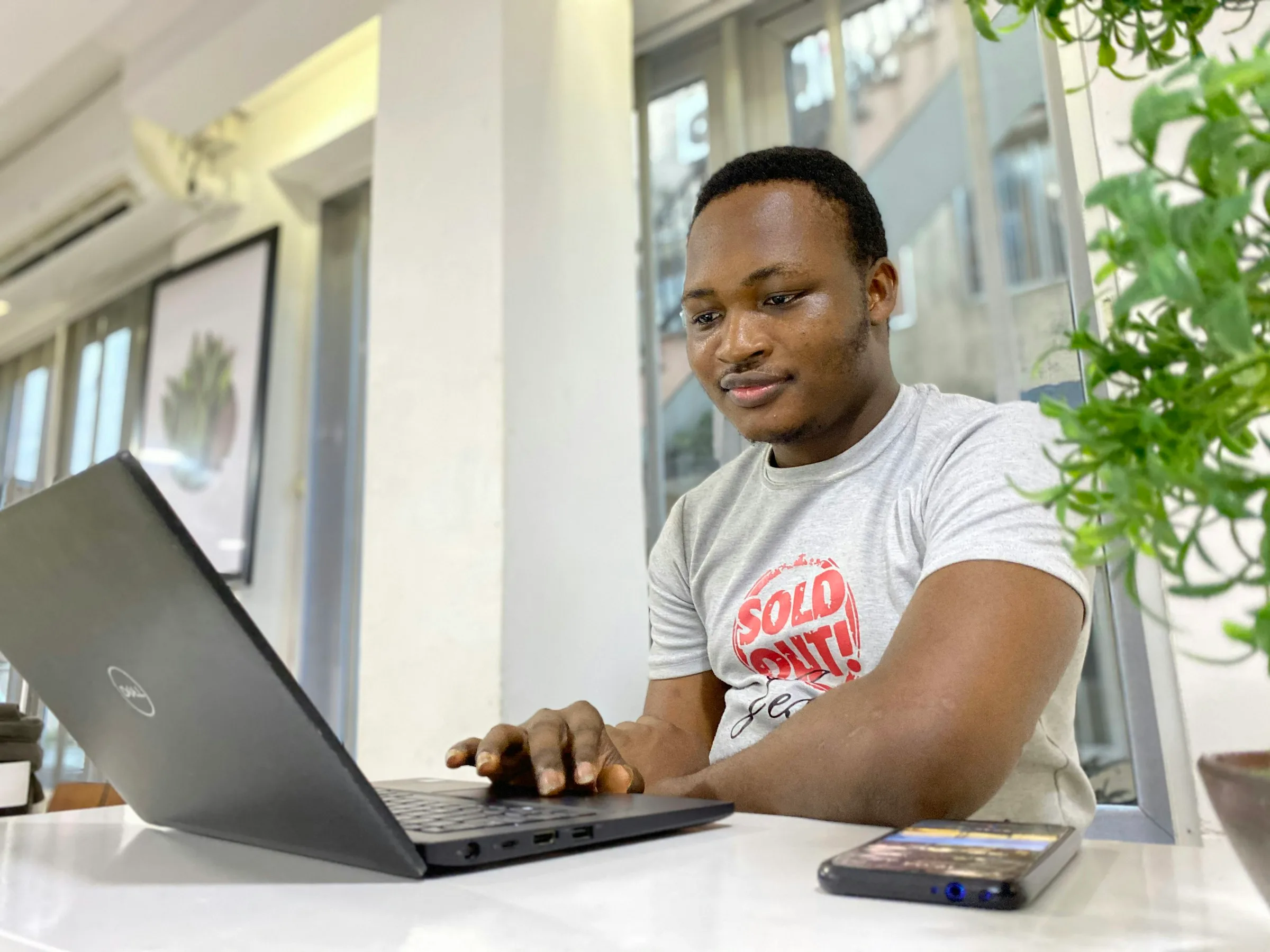A man working on a laptop in a bright office